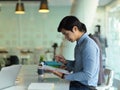 Businessman focusing on his on his paperwork while meeting with his colleagues