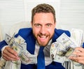 Businessman formal suit hold cash dollars hands. Che k out my profit this month. Earn money easy business tips. Man Royalty Free Stock Photo