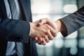 Businessman in formal suit making handshake with partner outdoors. Business people shaking hands finishing up a meeting.