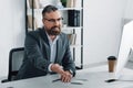 Businessman in formal wear talking in video chat in office Royalty Free Stock Photo