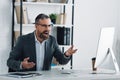 Businessman in formal wear talking in video chat in office Royalty Free Stock Photo