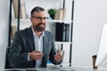 Businessman in formal wear talking in video chat in office Royalty Free Stock Photo