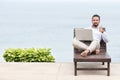 Businessman freelance on beach with laptop Royalty Free Stock Photo