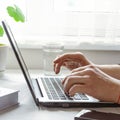 Businessman, freelancer holding pen, using mobile smart phone, working on laptop computer at home Royalty Free Stock Photo