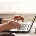 Businessman, freelancer holding pen, using mobile smart phone, working on laptop computer at home Royalty Free Stock Photo