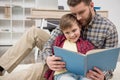 Businessman freelancer reading book with son Royalty Free Stock Photo