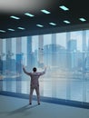 Businessman in front of office window thinking of new challenges Royalty Free Stock Photo