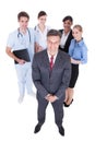 Businessman in front of professional workers Royalty Free Stock Photo