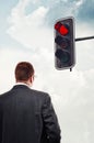 Businessman in front of red traffic light Royalty Free Stock Photo