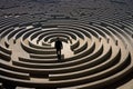 businessman in front of a round maze in the middle of it, A businessman walking in a labyrinth maze, AI Generated Royalty Free Stock Photo