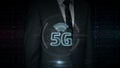 Businessman with 5G symbol hologram