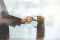 businessman gambling placing wooden block on a tower - planning, risk and strategy in business Royalty Free Stock Photo