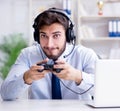 Businessman gamer in office playing games