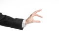 Businessman and gesture topic: a man in a black suit and white shirt showing hand gesture on an isolated white background in Royalty Free Stock Photo