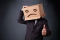 Businessman gesturing with cardboard box on his head with sad fa Royalty Free Stock Photo