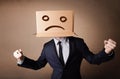 Businessman gesturing with cardboard box on his head with sad fa Royalty Free Stock Photo
