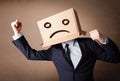 Businessman gesturing with cardboard box on his head with sad fa Royalty Free Stock Photo