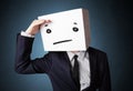 Businessman gesturing with a cardboard box on his head with stra Royalty Free Stock Photo