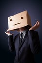 Businessman gesturing with a cardboard box on his head with stra Royalty Free Stock Photo