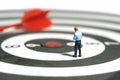 A businessman getting ready, justify the tie above dartboard with red arrow. Image photo