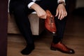 Businessman getting ready for work. Putting his shoes on. man puts on his brown shoes Royalty Free Stock Photo