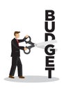 Businessman with a giant scissor cutting a budget block