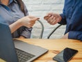 Businessman giving business card to businesswoman in the office. Business Partner Concept Royalty Free Stock Photo