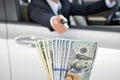 Businessman giving a car key exchanging with money Royalty Free Stock Photo