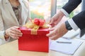 Businessman giving and opening red gift box businesswoman in office - Christmas and Happy new year concept Royalty Free Stock Photo