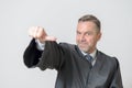Businessman giving a thumbs to side gesture Royalty Free Stock Photo