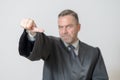 Businessman giving a thumbs to side gesture