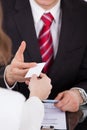 Businessman giving visiting card to colleague at desk Royalty Free Stock Photo