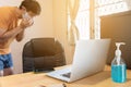 Blur of man with casual dress is coughing, working at home, focus at laptop