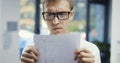 Businessman with glasses checking paperwork