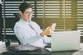 Businessman in glasses sitting at office desk with laptop Royalty Free Stock Photo
