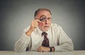 Businessman with glasses skeptically looking at you