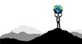 businessman with globe on mountain peak.