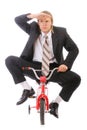 Businessman goes on children's bicycle