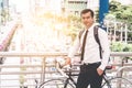 Businessman going to work by bike in a traffic jam city