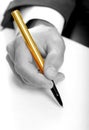 Businessman with gold pen Royalty Free Stock Photo