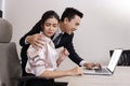 Businessman Grab his Secretary Shoulder While Looking at the Laptop in the Office in Office Sexual Harassment Concept