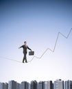 Businessman on a graph shaped tightrope