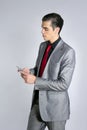 Businessman with gray suit talking cellular