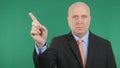 Businessman with Green Background Indicate a Direction with Finger Sign