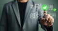 Man in suit pressing digital certifications documents with green check marks Royalty Free Stock Photo