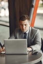 Businessman sitting at thecafe with laptop Royalty Free Stock Photo