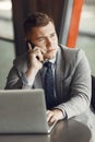 Businessman sitting at thecafe with laptop Royalty Free Stock Photo