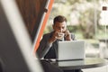 Businessman sitting at thecafe with laptop Royalty Free Stock Photo