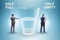 Businessman in half empty half full glass concept Royalty Free Stock Photo