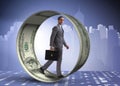 The businessman in hamster wheel chasing dollars